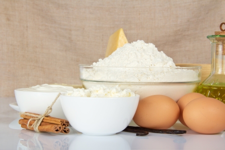 Cottage cheese, sour cream, eggs, a flour against a canvasの写真素材