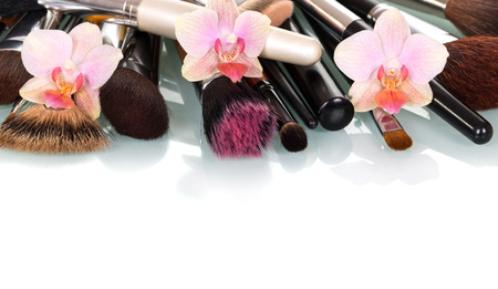 Cosmetic Makeup Brush and orchid flowers isolated on white background.の写真素材