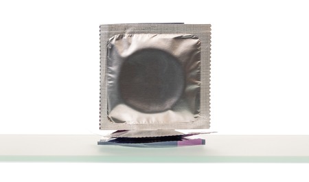 Condoms in pack close-up isolated on white background.の写真素材