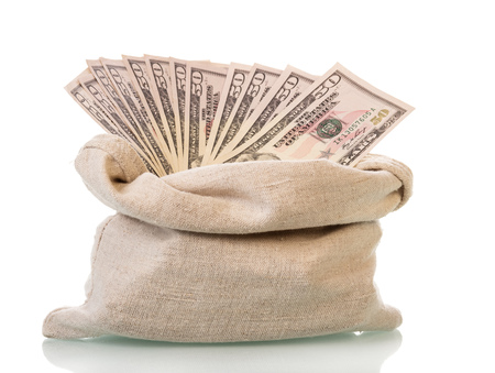 Dollar bills in a bag isolated on white background.の写真素材