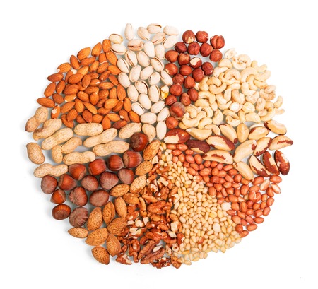 Various whole and peeled nuts isolated on white background.の写真素材