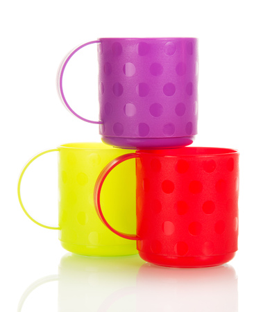 Three colorful plastic cups isolated on white background.の写真素材
