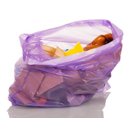 Open Purple plastic bag with trash isolated on white background.の写真素材