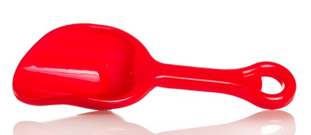 Red plastic scoop for the sandbox isolated on white background.の写真素材