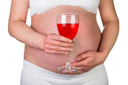 Pregnant woman with a glass of red wine in hand isolated on white background.の写真素材