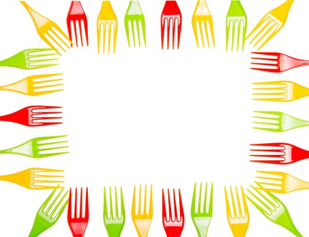 Bright plastic forks laid out in the form of a rectangular frame isolated on white background.の写真素材