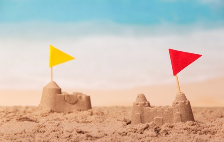 Sandcastles with checkboxes close-up on a background of the sea.の写真素材