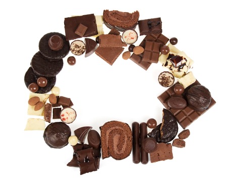 Round frame from a variety of chocolates isolated on white background.の写真素材
