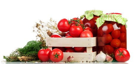 Wooden box of fresh tomatoes, jars of pickled and red pepper isolated on white background.の写真素材