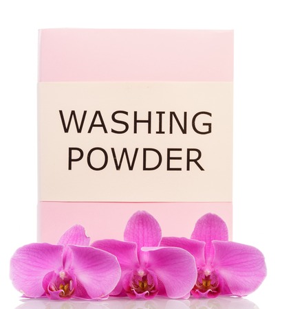 A pack of washing powder and orchid flowers isolated on white background.の写真素材