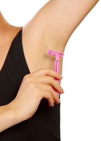 Hand woman shaves armpit disposable razor isolated on white background.の写真素材