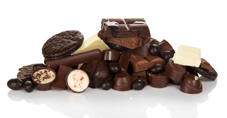 Pile of different chocolate candies isolated on white background.の写真素材