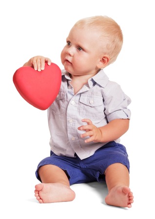 Female hand and the hand of a little boy sitting holding red heart isolated on white background.の写真素材