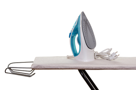 Steam iron and ironing board isolated on white background.の写真素材