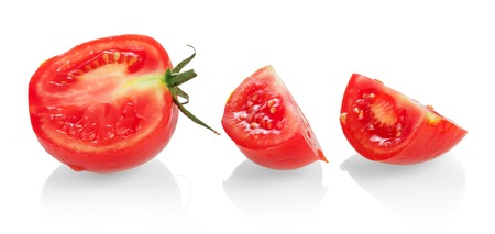 Half of tomato and slices closeup isolated on a white background.の写真素材