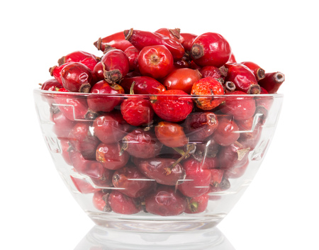 Are dry dog rose berries in a glass bowl isolated on white background.の写真素材
