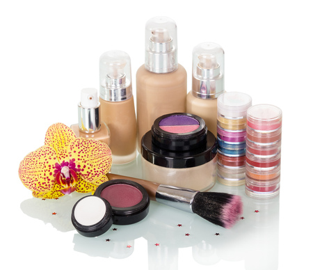 A set of makeup, brush for makeup and orchid flower isolated on white background.の写真素材