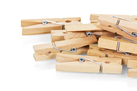 Wooden clothespins close-up isolated on white background.の写真素材