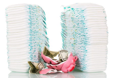 Stacks of children's disposable diapers, broken piggy bank and money isolated on white background.の写真素材