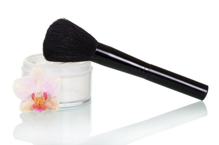 Bank of the cream for the face, cosmetic brush and orchid flower isolated on white background.の写真素材