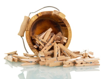 Wooden bucket with clothespins isolated on white background.の写真素材