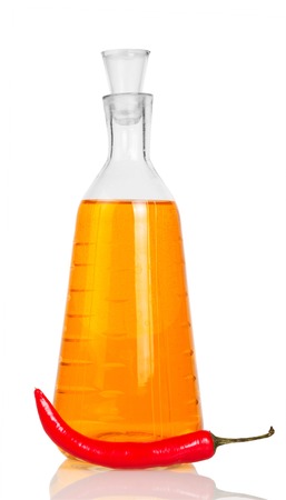 Bottle of vodka and red chili peppers isolated on white background.の写真素材