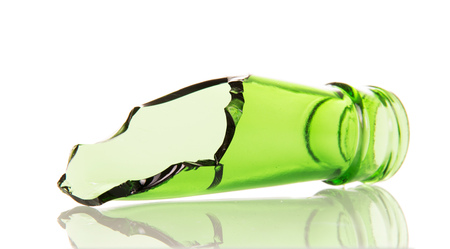 The neck of a broken glass bottle isolated on white background.の写真素材