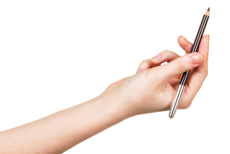 Eyebrow Pencil in a female hand isolated on white background.の写真素材