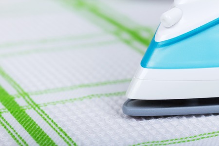 The front part of the steam iron, ironing cotton towel background.の写真素材