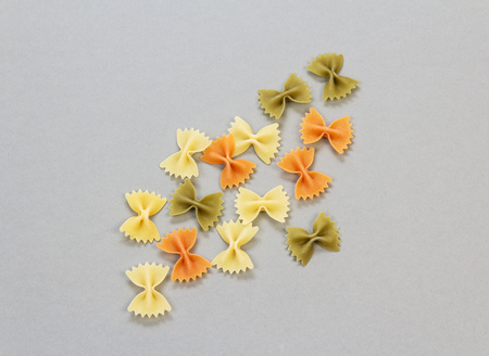 Farfalle pasta close-up on a light gray background.