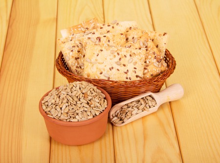 Peeled sunflower seeds and crispy cookies on a background of light wood.の写真素材