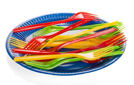 Disposable plastic plate and multicolored plugs isolated on white background.の写真素材