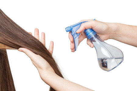 Hands parekmahera prepared long hair in a hairstyle isolated on white background.の写真素材