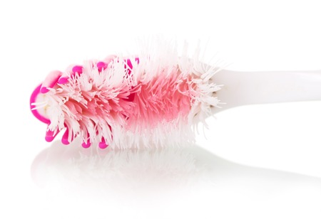 A worn toothbrush isolated on white background.の写真素材