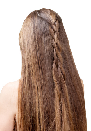 Well-groomed, beautiful hair of a young girl partially braided in a braid. Isolated on white background.の写真素材