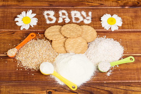 Baby biscuits made from three kinds of flour in a dark wood.の写真素材
