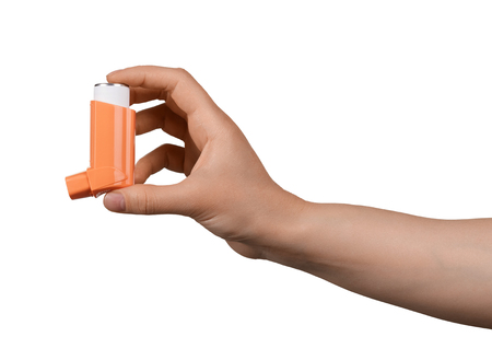 Small pocket inhaler in a female hand, isolated on white backgroundの写真素材