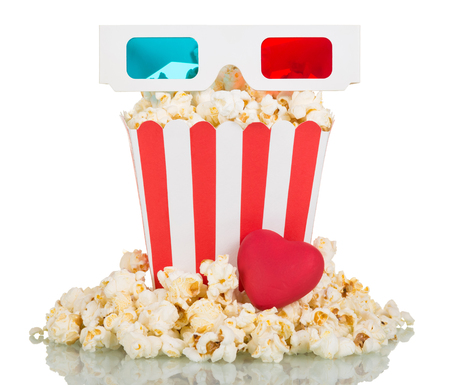 3D glasses, a large square box of popcorn, popcorn around and red heart isolated on white background.の写真素材