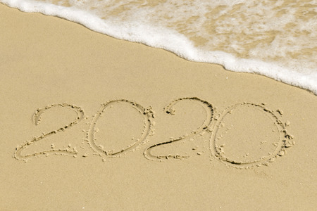 2020 inscription on sand with sea foam of the seaの写真素材