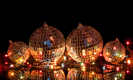 Big and small Christmas balls with mirror surface isolated on  black backgroundの写真素材