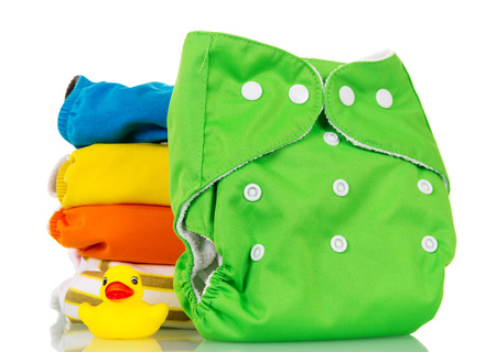 Bright modern environmentally friendly diapers and a rubber duckling isolated on white background.の写真素材