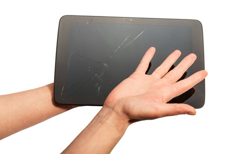 In female hands the broken tablet isolated on a white background.の写真素材