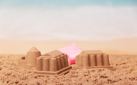 The palaces and towers of sand toy on the coast.