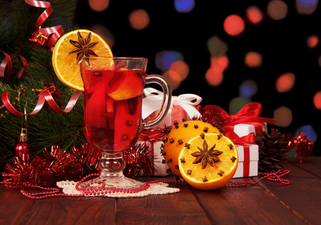 Mulled wine, Christmas tree and gifts on abstract dark background.の写真素材