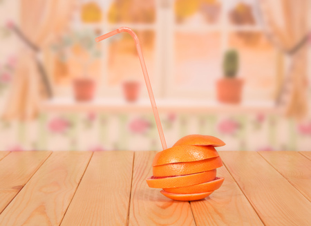 Ripe grapefruit, cut into circles, folded as a unit over the kitchen background.の写真素材
