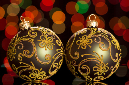 Two beautiful Christmas balls with a pattern on a dark flickering backgroundの写真素材
