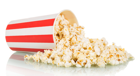 Popcorn was scattered from a large striped box, isolated on white background.の写真素材