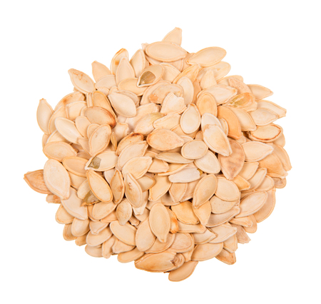 Heap of fried pumpkin seeds isolated on white background.の写真素材