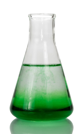 A chemical flask with a transparent green liquid is isolated on a white background.の写真素材