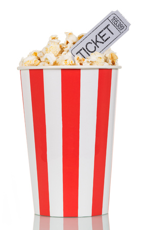 Large striped popcorn box with gray cinema ticket on a white background.の写真素材